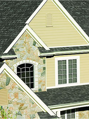 Finished asphalt shingle roof and stone home exterior