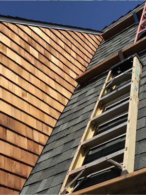 Wood shake roofing work with ladder