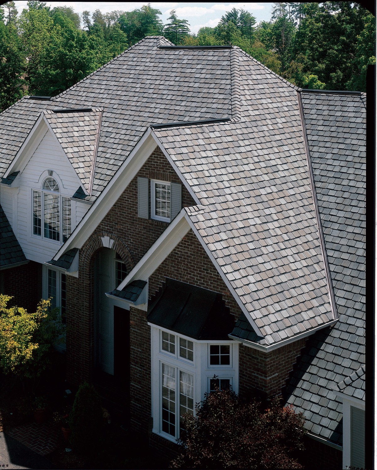 Gray shingle roof with steep gables and dormers