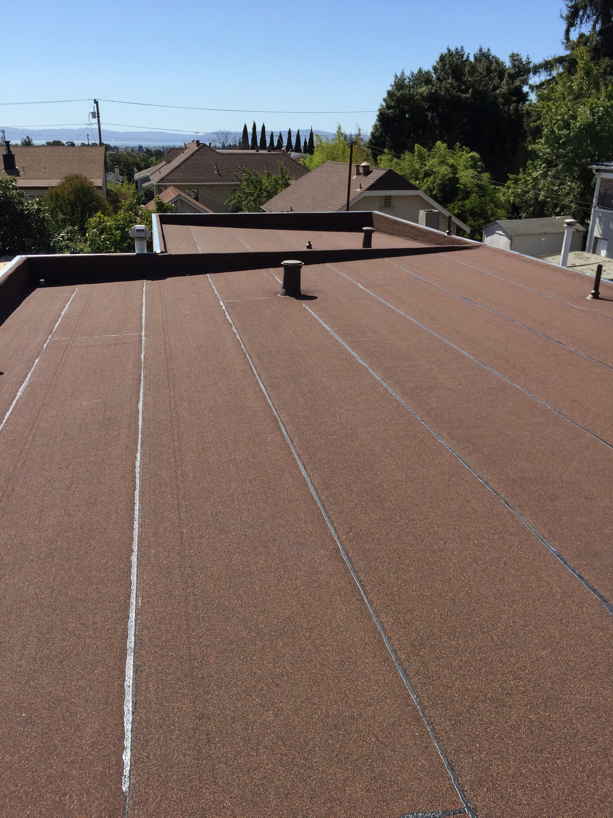 Brown low-slope roof with neatly finished seams