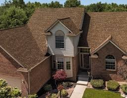 Brown shingle roof surrounding a central dormer